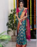 nyrika_teal_women_woven_motif_saree_with_contrast_border.jpg